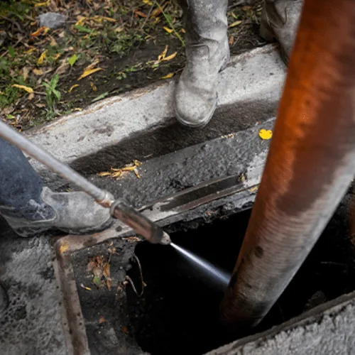 High pressure hydro jetting nozzle clearing a blocked septic line